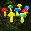 Six illuminated solar mushroom garden lights in various colors including red, green, yellow, and blue.
