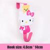A pink and white cartoon cat hook with a yellow kitten charm, designed for over-the-door hanging storage.