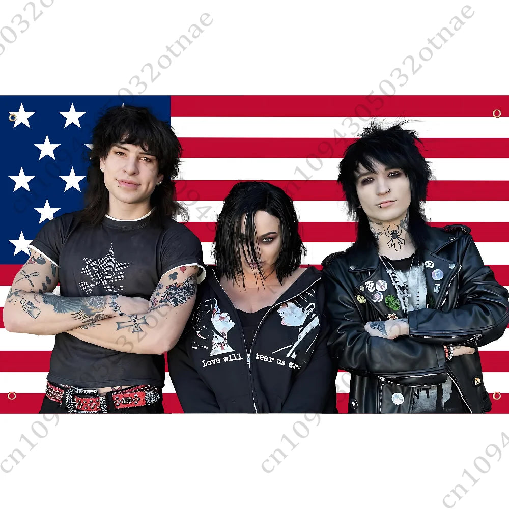 Three individuals posing in front of an American flag background.