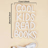 A white neon sign shaped like the words COOL KIDS READ BOOKS, measuring 17cm long.