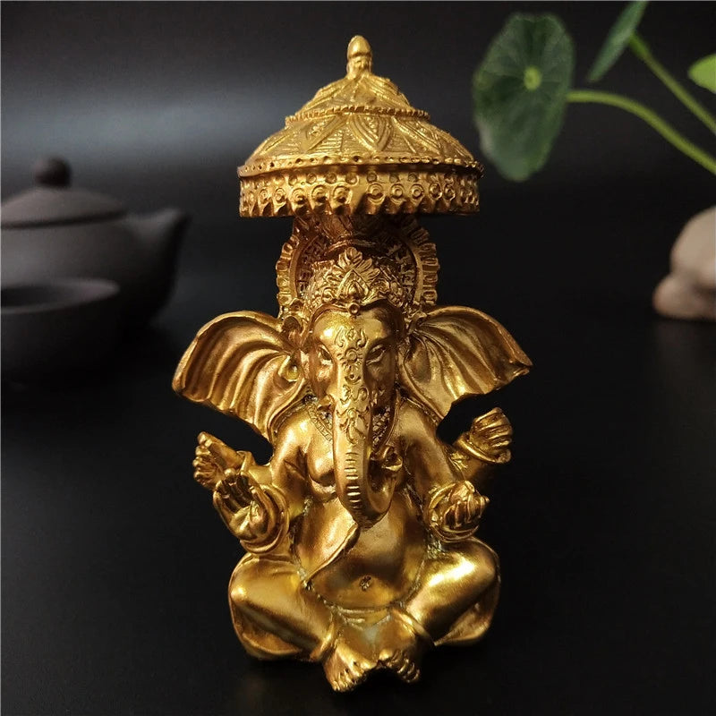 A golden bronze statue of Ganesha Buddha seated in a meditative pose, used for home decor.
