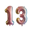Silver and pink helium foil number balloons spelling out 13