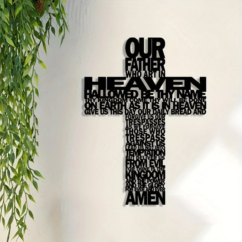 A black metal cross wall art decoration with text inscribed on the arms and foot.