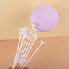 White macaron balloon sticks with holder cups arranged below a purple balloon disk for party decor