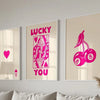 Three framed art prints featuring pink retro letter art saying LUCKY YOU on a light background
