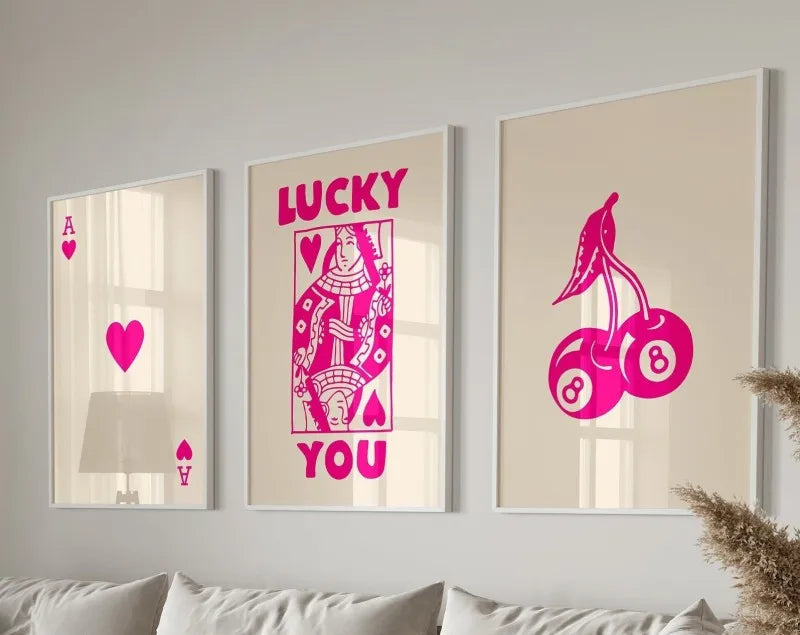 Three framed art prints featuring pink retro letter art saying LUCKY YOU on a light background