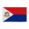 A rectangular flag design featuring red and blue fields with a white triangle and an emblem.