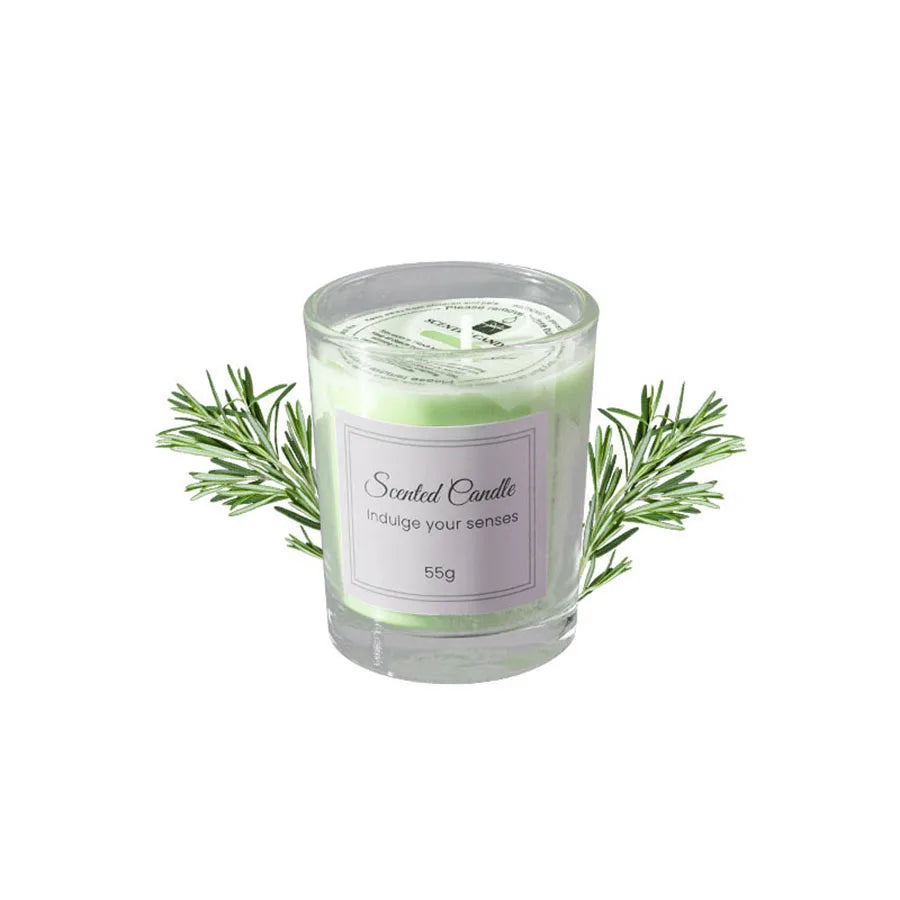 A glass jar of scented candle with green herbs and a label reading Scented Candle Indulge your senses