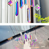 A collection of seven crystal prism sun catchers hanging in a vertical display against a light background.