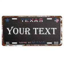 A dark metal license plate sign with the word TEXAS and space for custom text, featuring stars and an American flag motif.