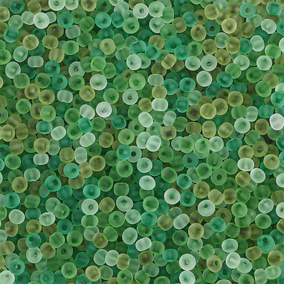 A close-up view of small, round, translucent green glass beads used for jewelry making.