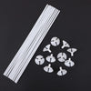 White macaron balloon sticks with holder cups arranged diagonally on a dark background