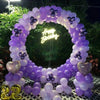 A purple and white balloon garland arch kit featuring balloons in various shades and metallic accents.