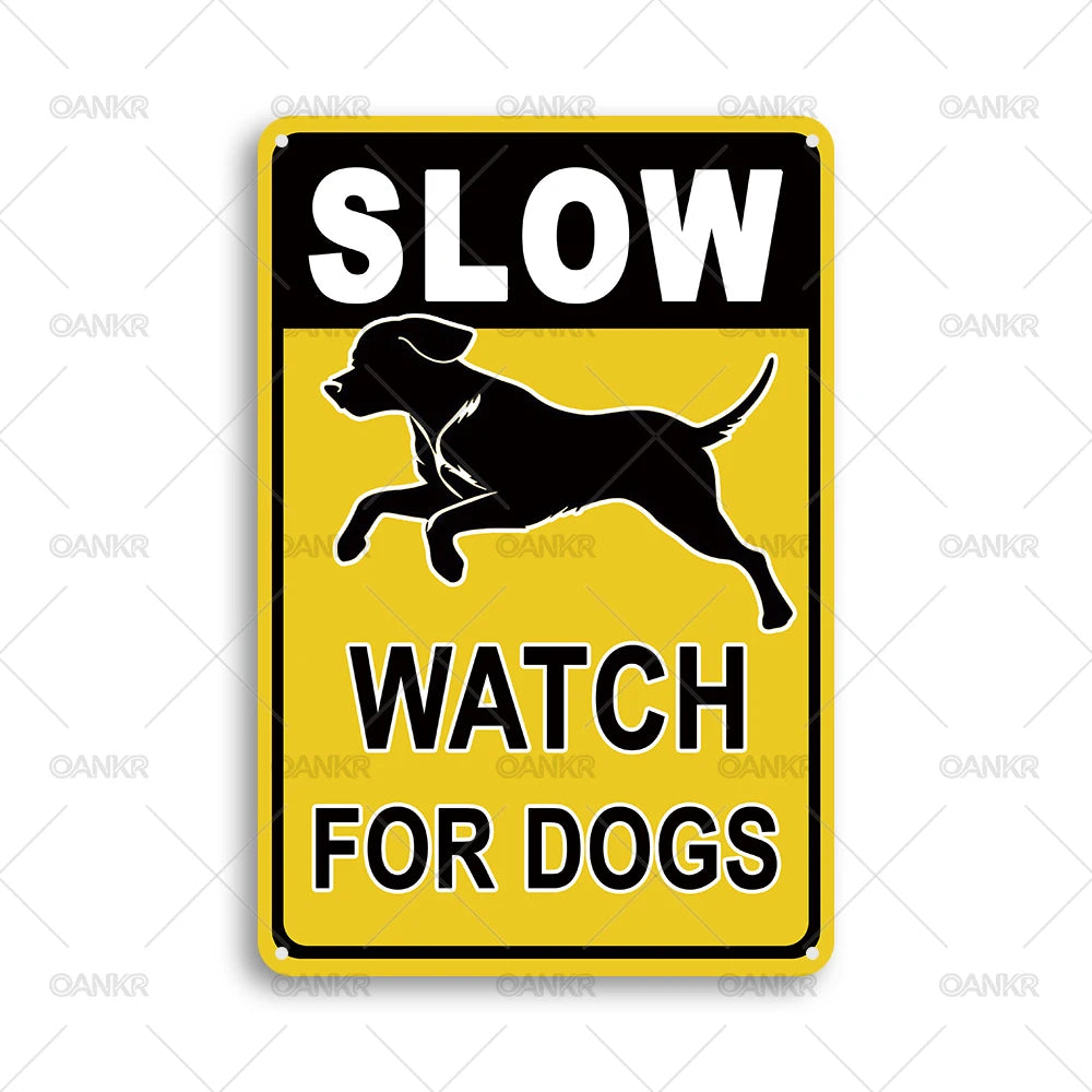 A yellow and black vintage metal tin sign with the text SLOW WATCH FOR DOGS and a silhouette of a dog running.