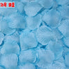 A pile of light blue silk rose petals used for weddings and events.
