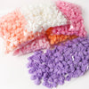Assortment of pink, peach, and purple PE foam artificial rose flowers in clear packaging.