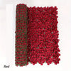 A dense screen of artificial red cherry blossoms used as a privacy fence or decorative screen.