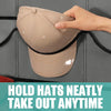 A hand is holding a beige clear door hat organizer with a black strap, demonstrating how to neatly take out hats.
