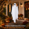A white ghost decoration hangs outdoors on a porch, decorated for Halloween with autumn foliage and pumpkins.