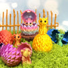 A collection of colorful 3D printed dragon eggs and mini dragon toys displayed on green moss.