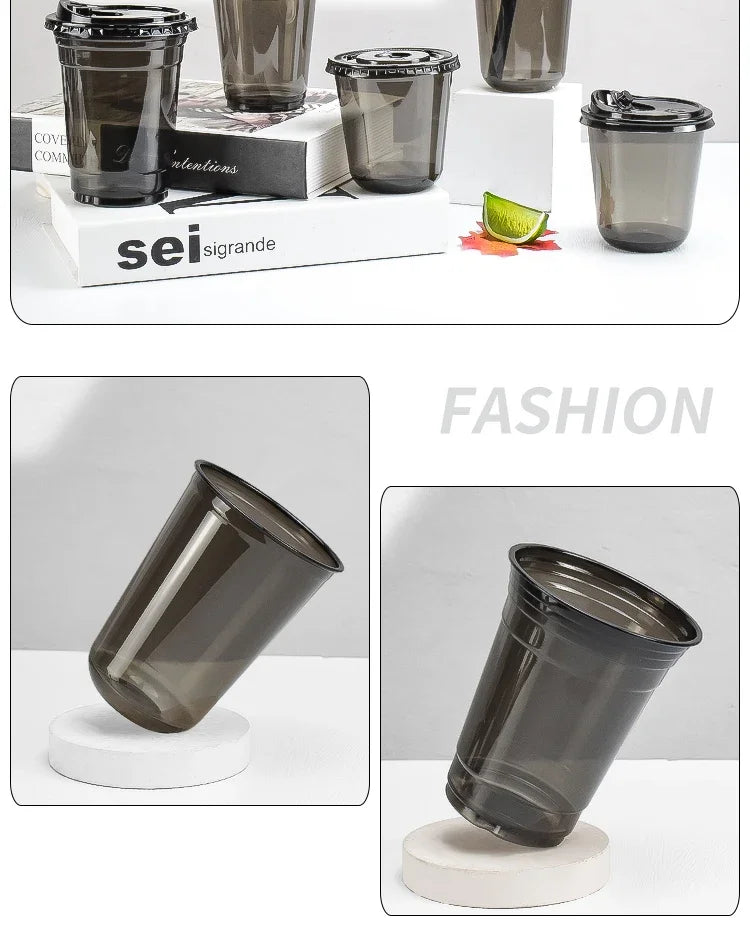 A set of disposable U-shaped coffee cups in black glass are displayed on a white surface.