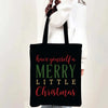 A black tote bag with pink and green text that reads Have yourself a Merry Little Christmas
