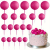 A set of twenty bright pink mini foam ball cake toppers on white sticks.