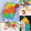A vibrant rainbow glitter mix in a rectangular card, alongside round glitter balls and a nail art product.