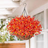 A realistic artificial flower hanging basket filled with bright orange and red blossoms, suspended from the ceiling.