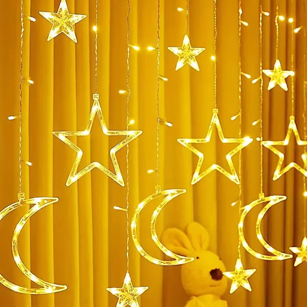 Golden star and crescent moon LED string lights hanging against a yellow curtain backdrop