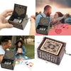 An antique wood music box with an engraved melody is shown open and closed, featuring intricate patterns.