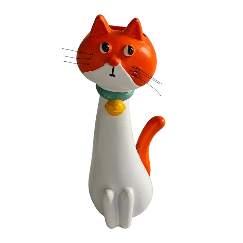 An orange and white cat-shaped resin vase for dried flowers.