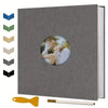 A gray magnetic scrapbook album with a circular photo holder and a yellow tool.