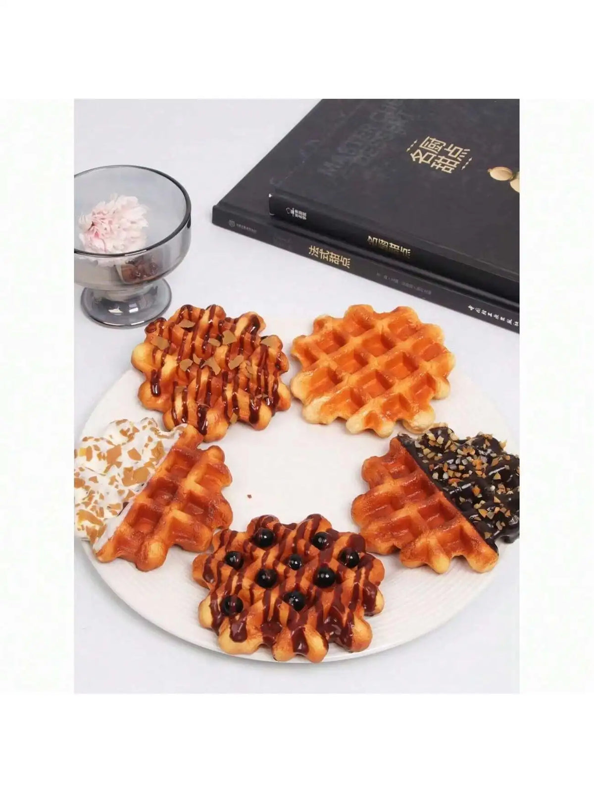 A plate of realistic waffle food replicas including waffles, syrup, and a glass of pink dessert.