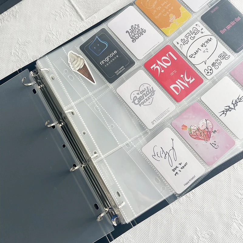 A large capacity grid binder filled with various photocards and accessories like a ringnose card and stickers.