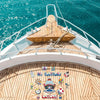 A wooden boat deck with railings and a nautical magnet set featuring captain designs and a cruise theme.