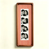 A wooden photo strip frame with a red and white striped background displaying several close-up couple photos.
