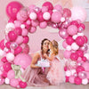 A pink balloon arch decorated with assorted latex balloons for a celebration featuring two young girls.