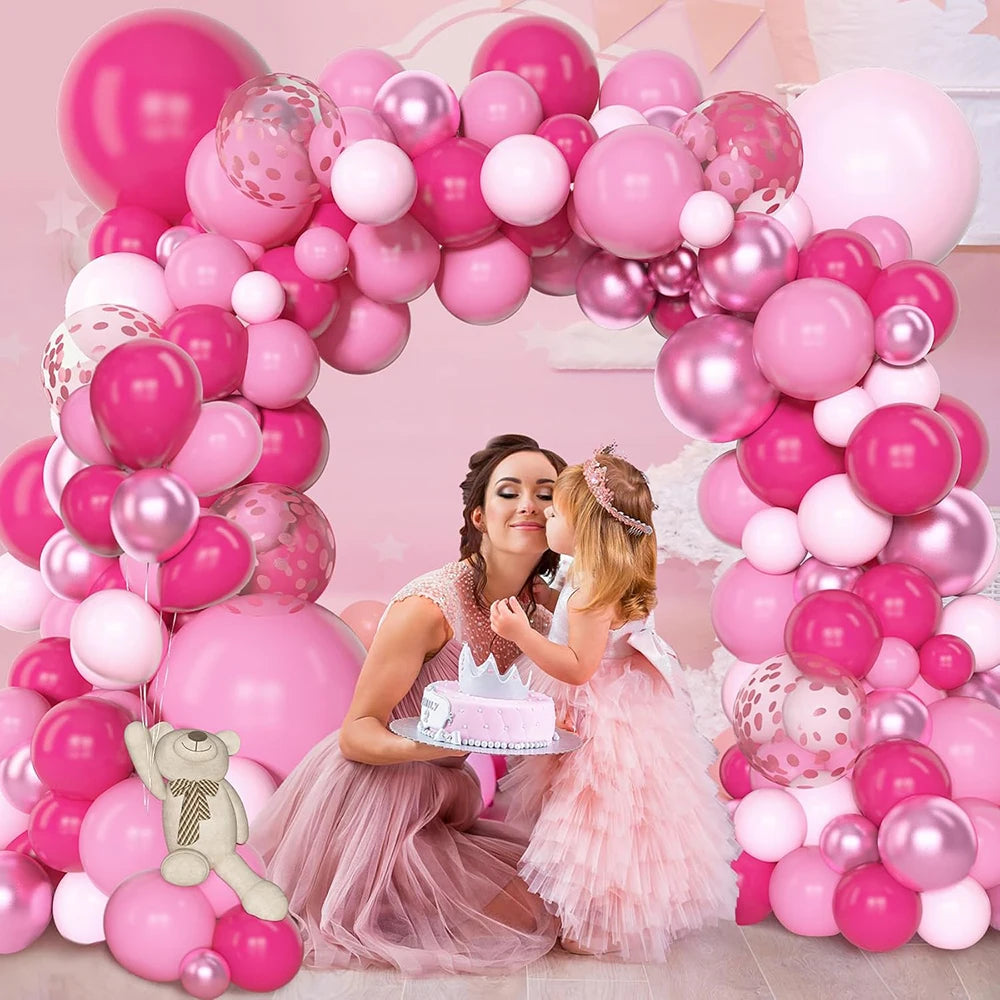 A pink balloon arch decorated with assorted latex balloons for a celebration featuring two young girls.