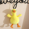 A yellow duck plush keychain pendant hanging against a light background.