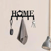 A black wall key holder with a heart design features hooks for hanging keys and a folded gray towel.