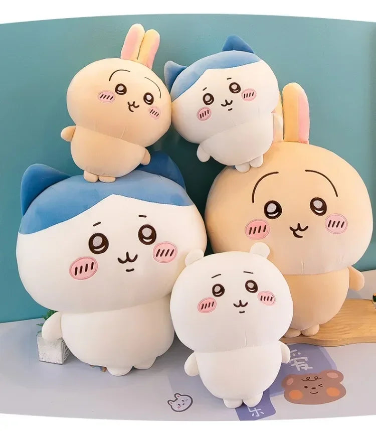 A collection of soft kawaii Chiikawa plush dolls in various colors including pink, blue, and cream.