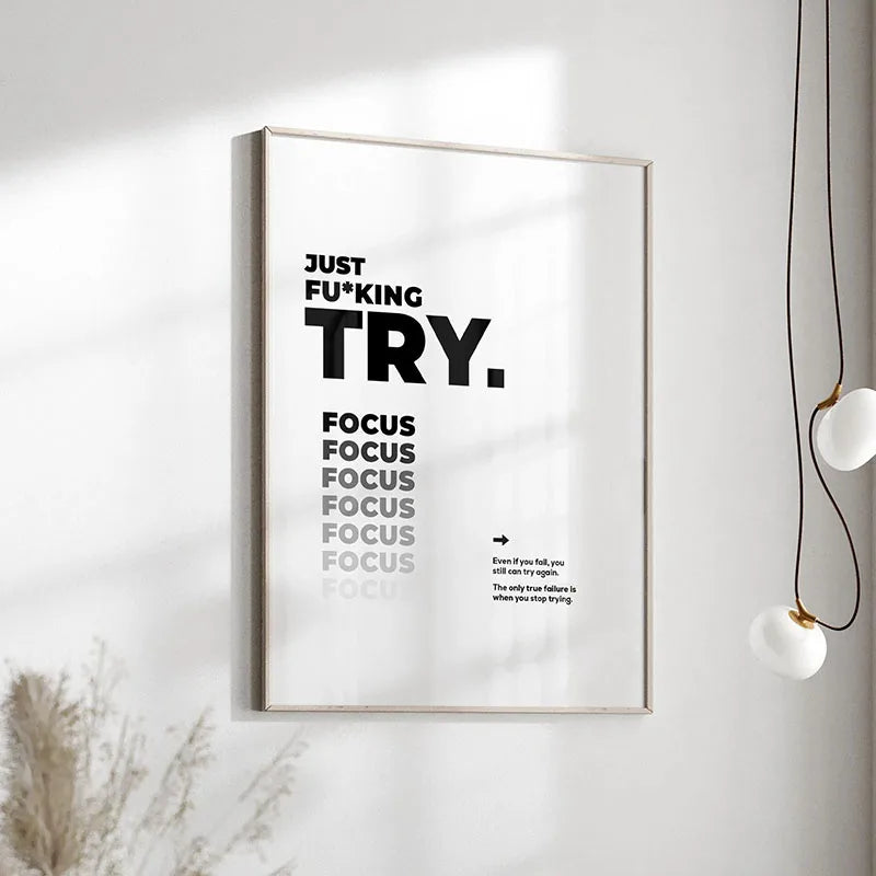 A framed canvas print with black text that reads Just FuKing Try Focus Focus Focus Focus Focus Even if you fail you still can