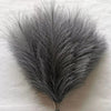 A bundle of gray artificial pampas grass stems used for boho wedding and home decor.