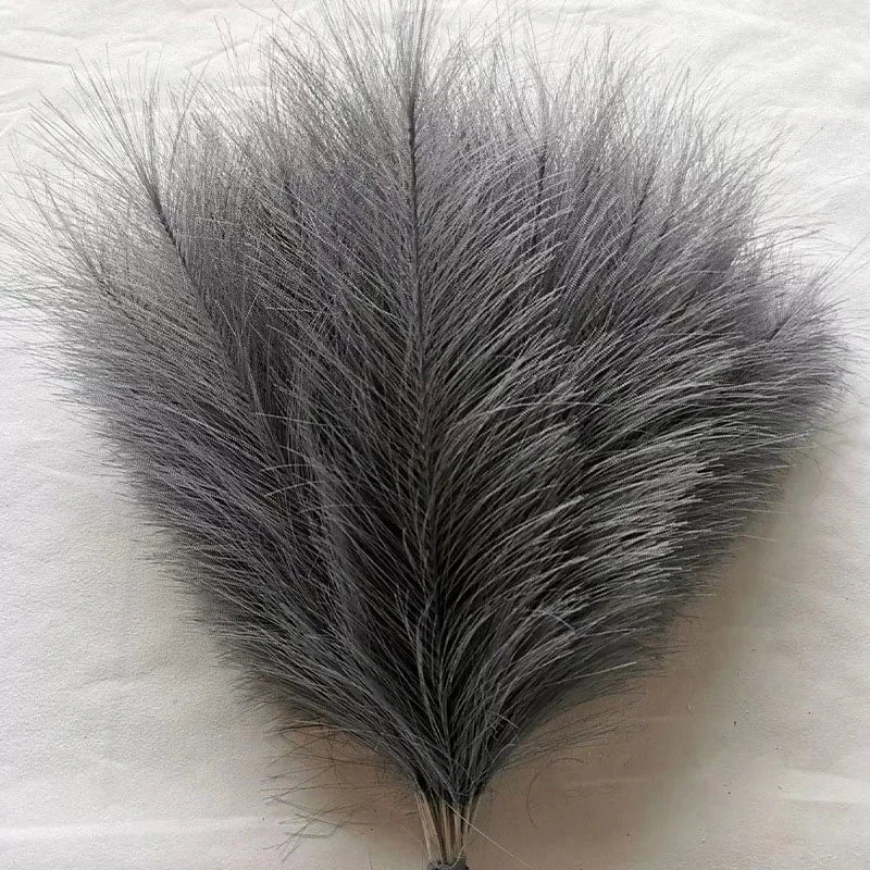 A bundle of gray artificial pampas grass stems used for boho wedding and home decor.