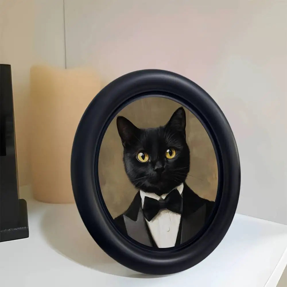 A black cat portrait in a round wooden photo frame with a dark background.