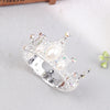 Silver tiara crown cake topper and hair accessory decorated with pearls and clear stones