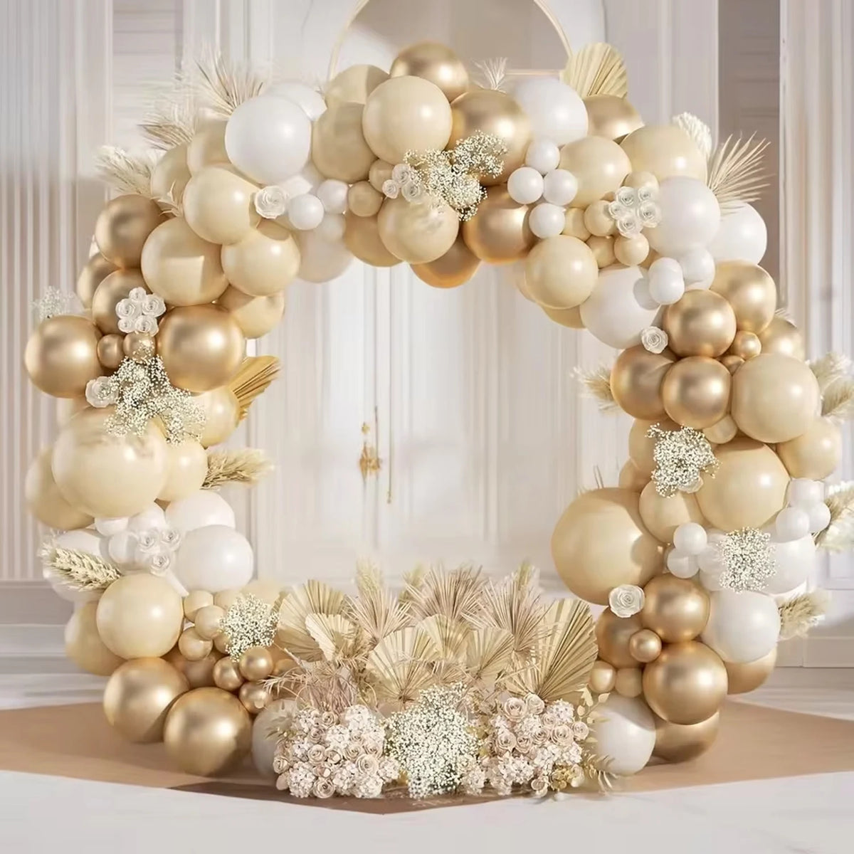 A large balloon garland featuring beige and gold balloons arranged in an archway.