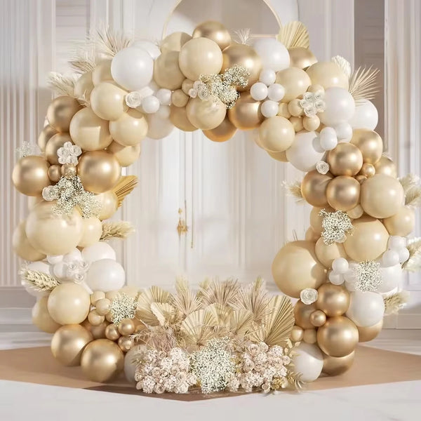 A large balloon garland featuring beige and gold balloons arranged in an archway.