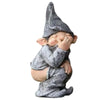A small statue of a gnome with a pointed hat and a surprised expression, painted in gray and white.